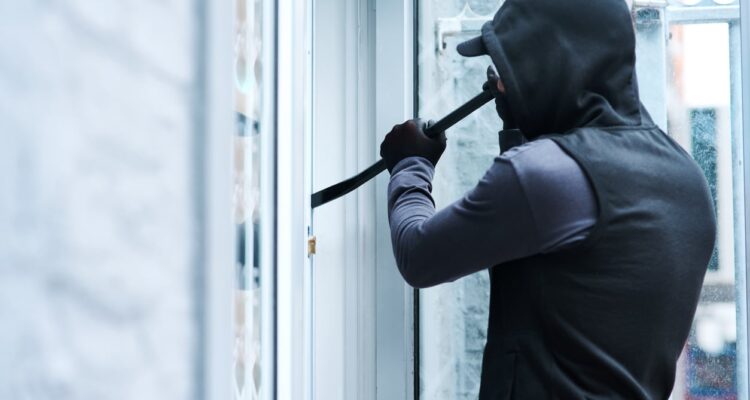 physical-security-risk-break-in-man-black-hoodie