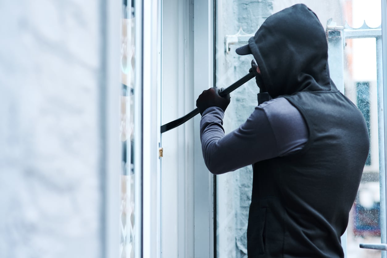 physical-security-risk-break-in-man-black-hoodie