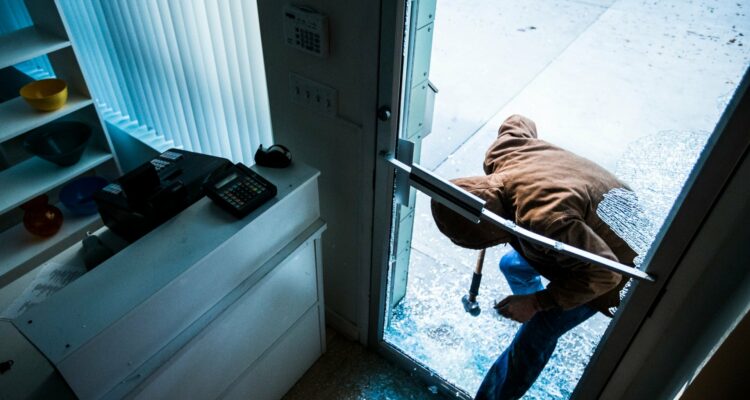 A Burglar Breaking Into A Business